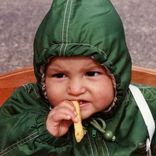 Photo of Andrea as a baby eating