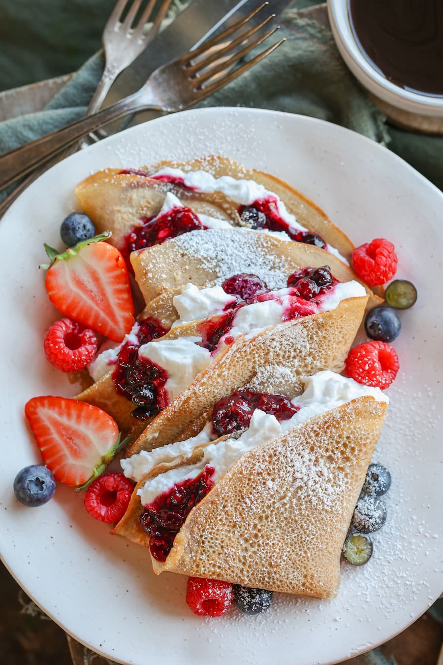Gluten-free buckwheat crepes with berries and whipped cream